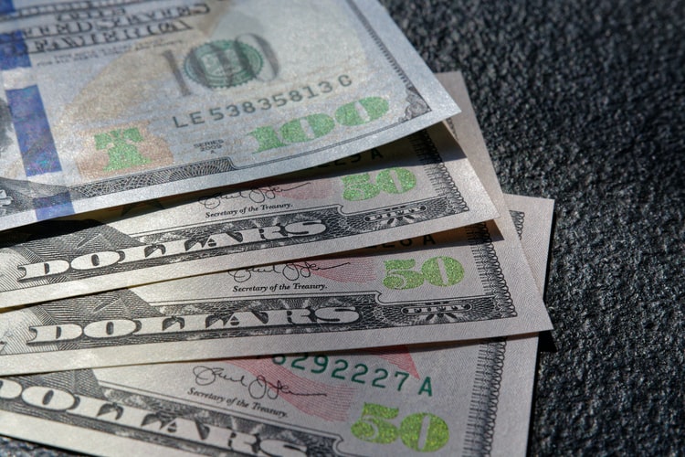 How does the falling US dollar affect world economy?